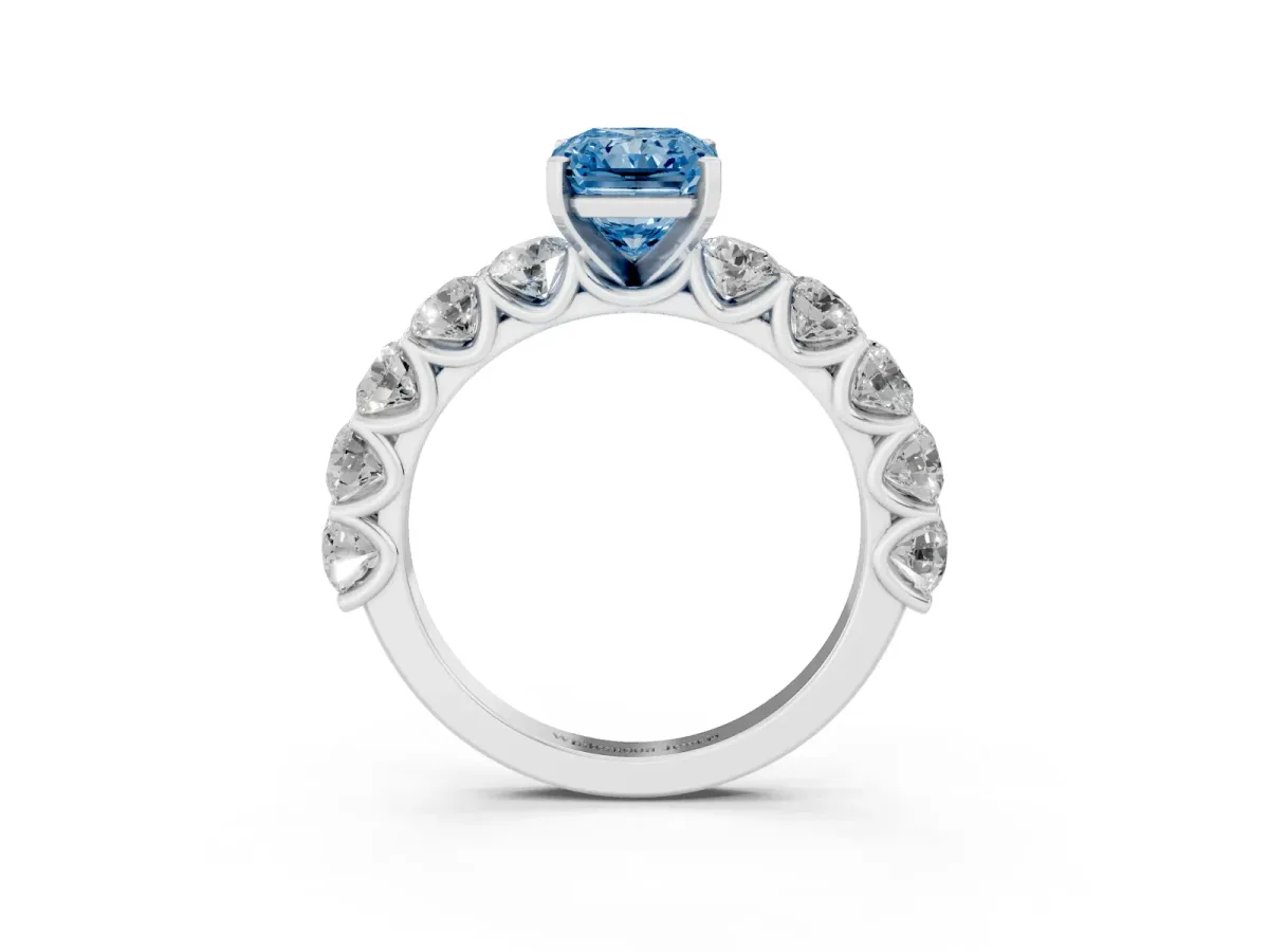 Fancy Blue Radiant Cut Diamond Prong Setting with Side Stones on a Pave Band Platinum