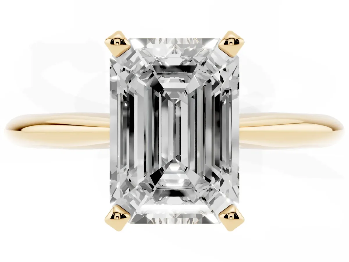 Emerald Cut Cut Solitaire Ring with Four-Prong Setting on a Classic Band Yellow gold