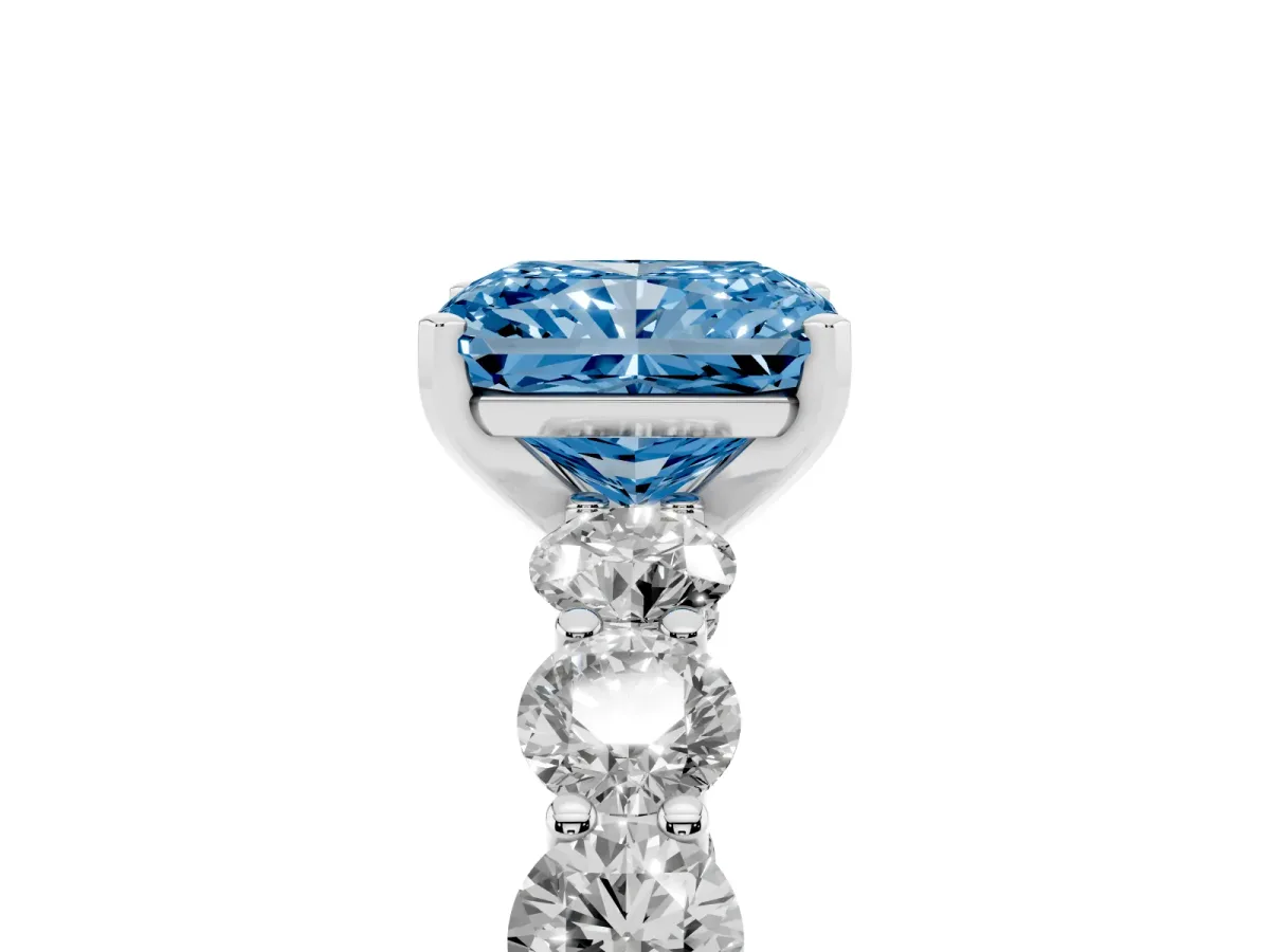 Fancy Blue Radiant Cut Diamond Prong Setting with Side Stones on a Pave Band Platinum