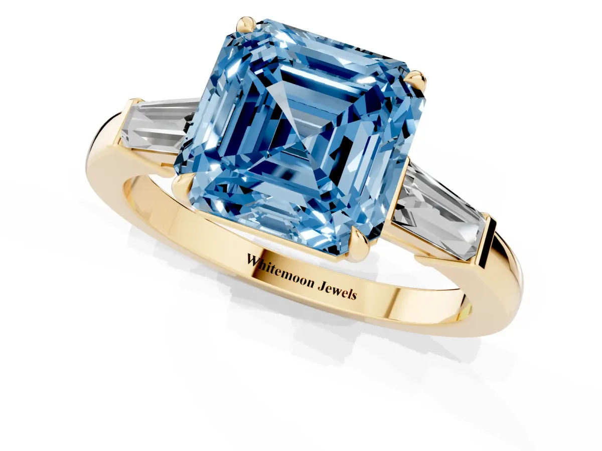 Fancy Blue Asscher Cut Diamond Three-Stone Ring with Tapered Baguette Side Stones and Prong Setting Yellow gold