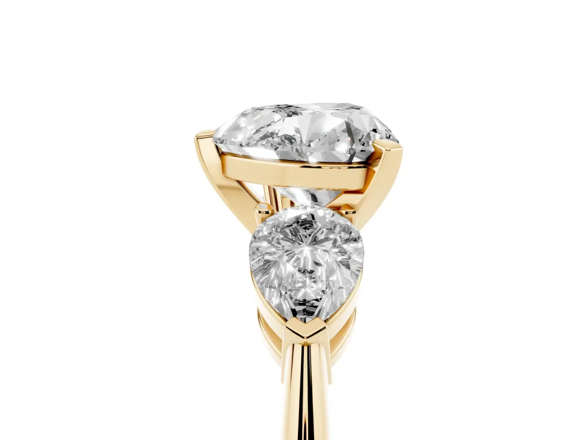 Three-Stone Heart Cut Diamond Ring with Pear Side Stones and Four-Prong Setting Yellow gold