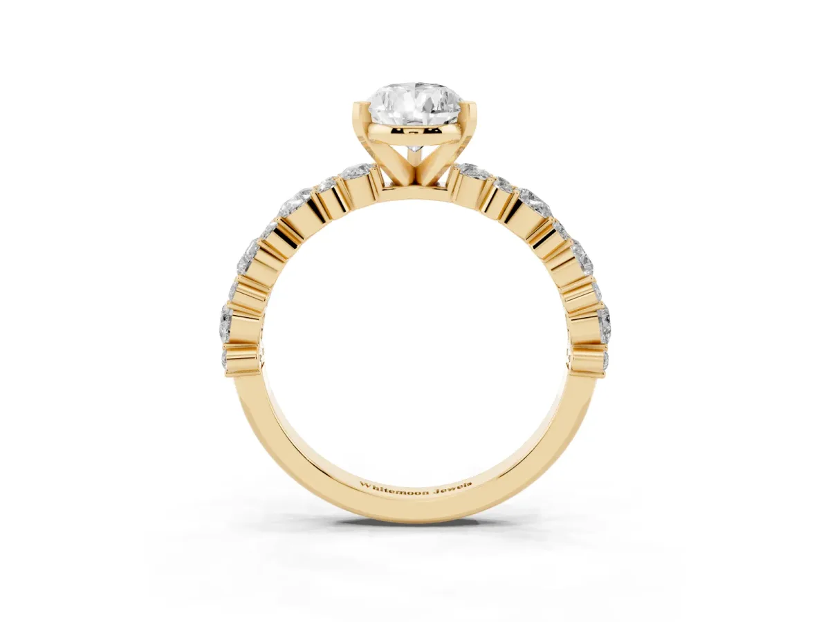 Pear Cut Diamond Side Stone Solitaire Ring with Round and Four-Prong Setting Yellow gold