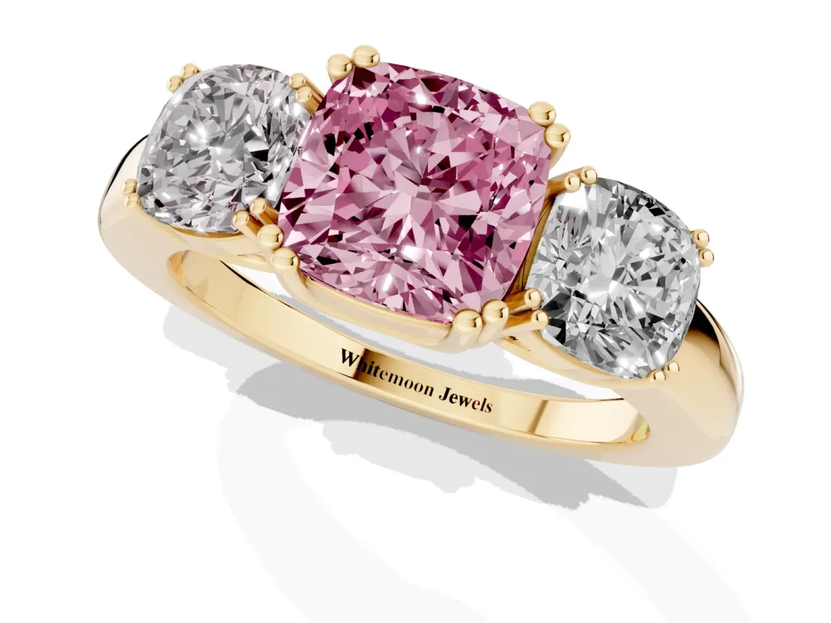 Fancy Pink Three-Stone Cushion Cut Cut Diamond Ring with Channel Set Band and Four-Prong Setting Yellow gold