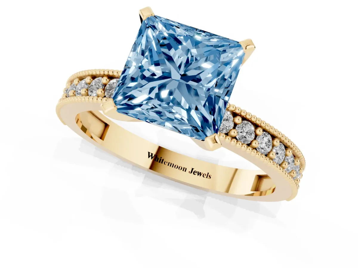 Fancy Blue Princess Cut Diamond Milgrain Pavé Engagement Ring with Four-Prong Setting Yellow gold