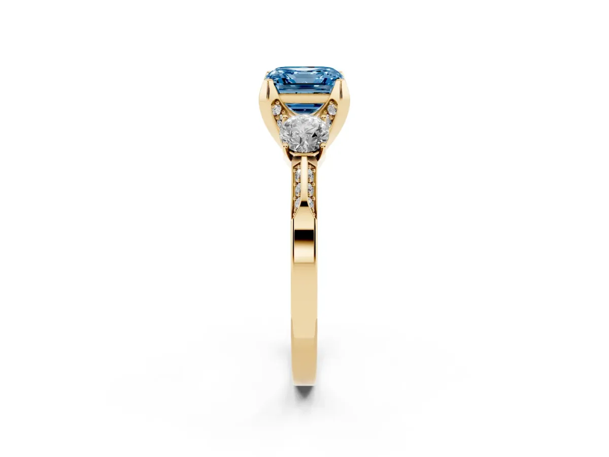 Fancy Blue Asscher Cut Brilliant Three-Stone Diamond Ring with Pavé Band and Four-Prong Setting Yellow gold