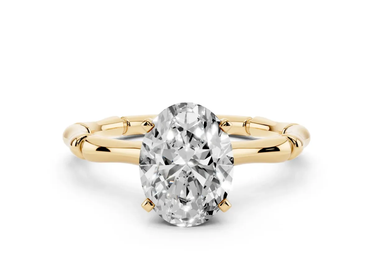 Oval Cut Solitaire Diamond Ring with Bamboo Band and Four-Prong Setting Yellow gold