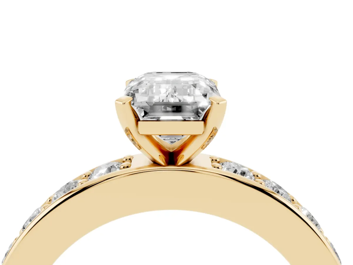 Emerald Cut Diamond Engagement Ring with Channel Set Round Band and Prong Setting Yellow gold