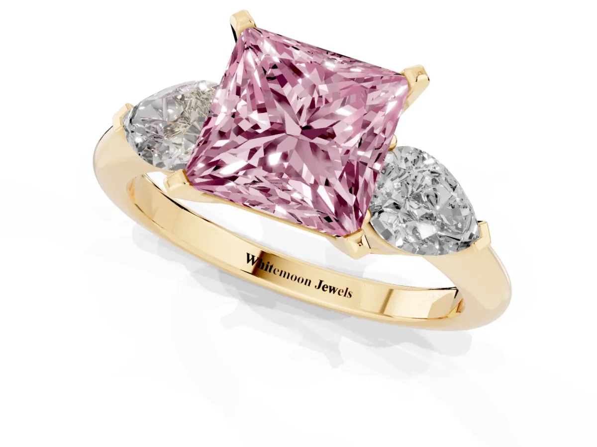 Fancy Pink Three-Stone Princess Cut Diamond Ring with Pear Side Stones and Four-Prong Setting Yellow gold
