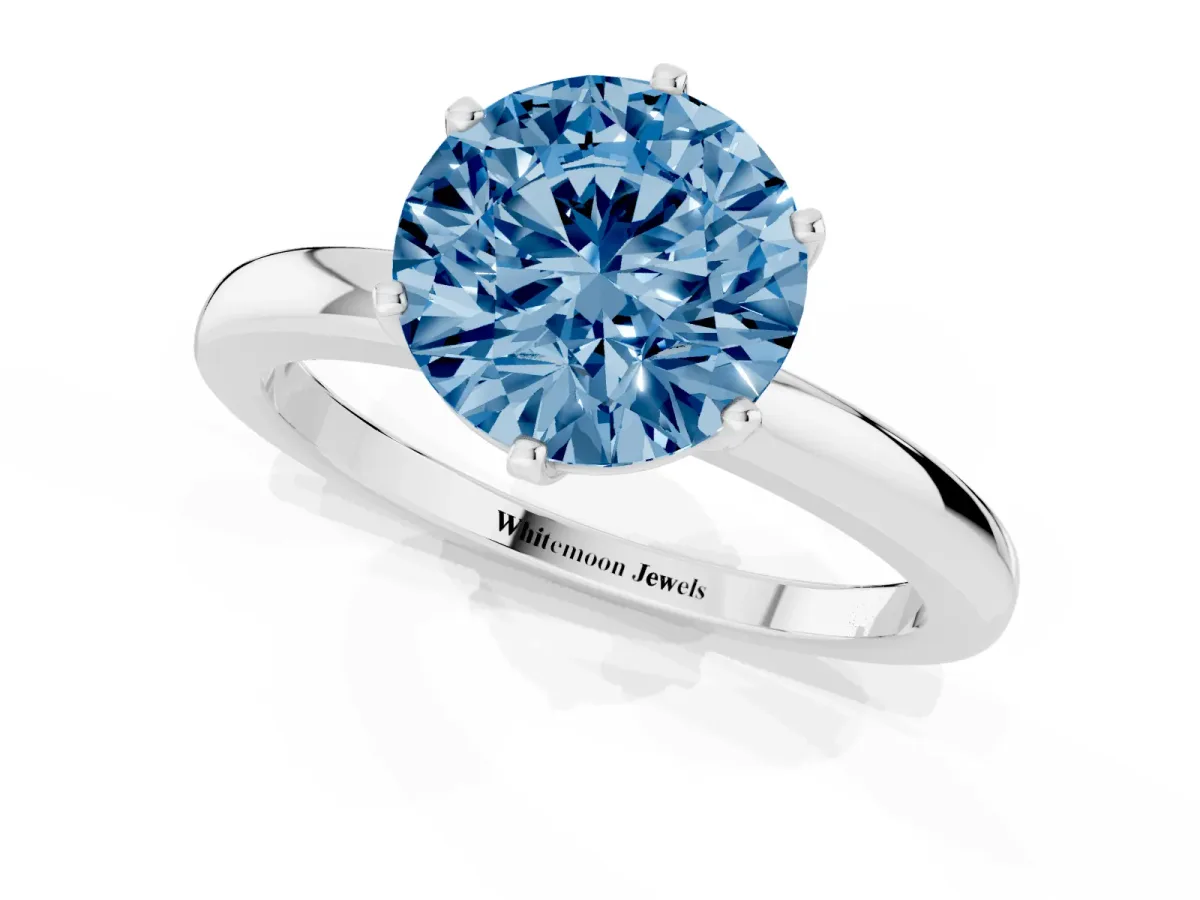 Fancy Blue Round Cut Solitaire Diamond Ring with Six-Prong Setting on a Classic Band Silver