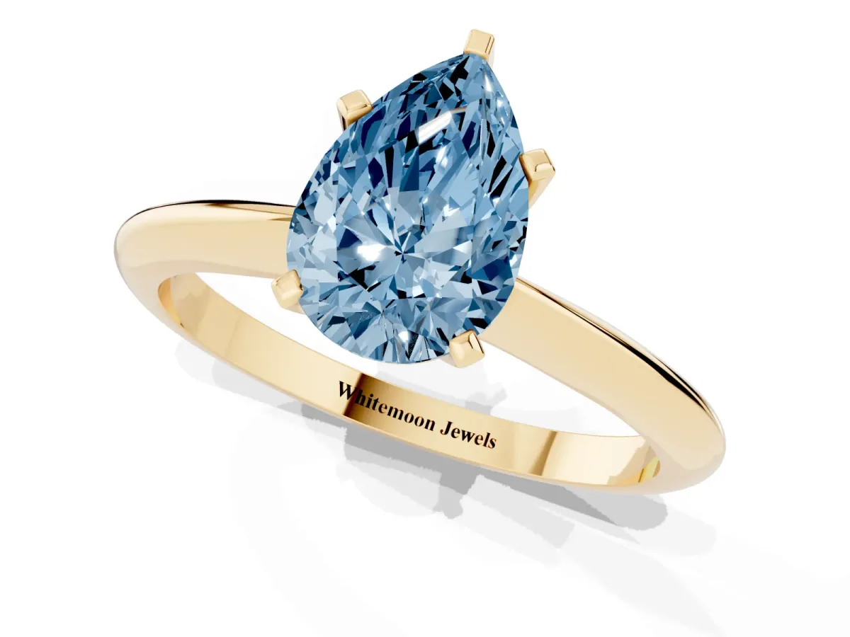 Fancy Blue Pear Cut Cut Solitaire Ring with Four-Prong Setting on a Classic Band Yellow gold