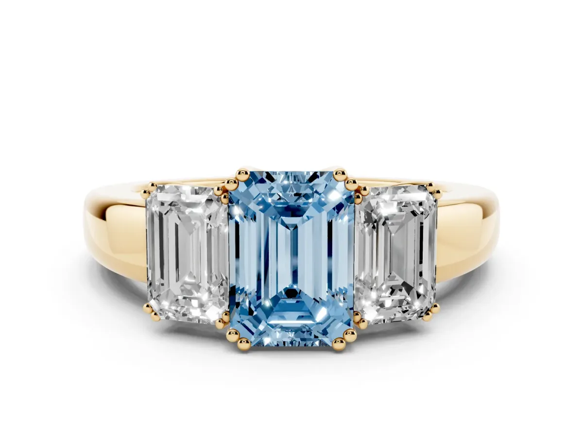 Fancy Blue Three-Stone Emerald Cut Cut Diamond Ring with Channel Set Band and Four-Prong Setting Yellow gold