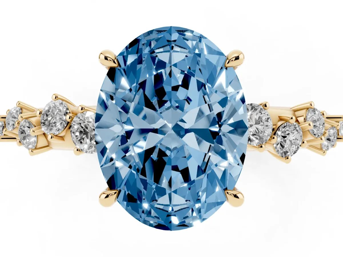 Fancy Blue Oval Cut Diamond Cluster Side Stone Solitaire Ring with Prong Setting Yellow gold