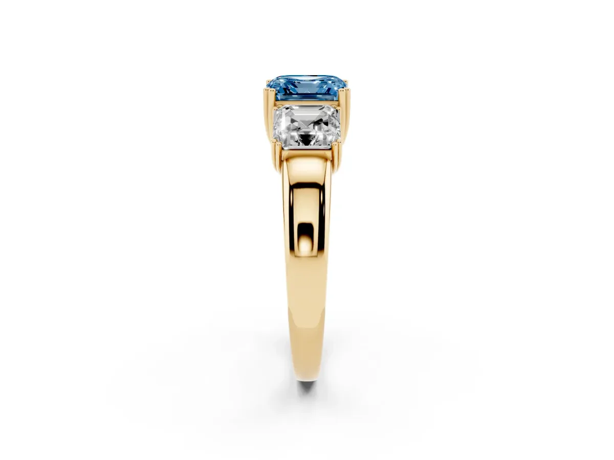 Fancy Blue Three-Stone Asscher Cut Cut Diamond Ring with Channel Set Band and Four-Prong Setting Yellow gold
