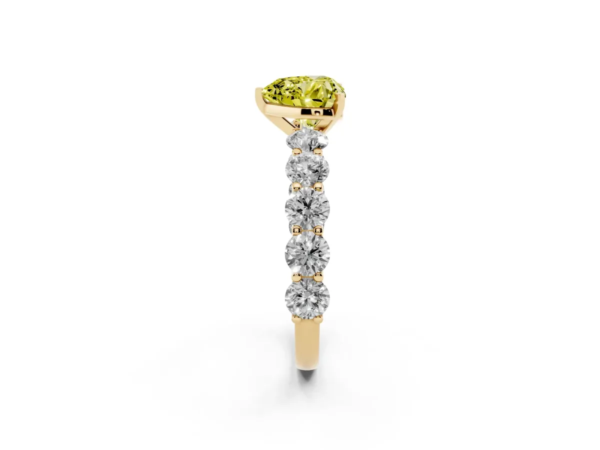 Fancy Yellow Heart Cut Diamond Prong Setting with Side Stones on a Pave Band Yellow gold