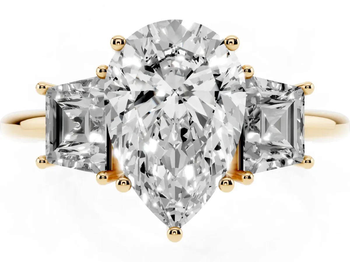 Pear Cut Diamond Three-Stone Ring with Trapezoid Side Stones and Prong Setting Yellow gold