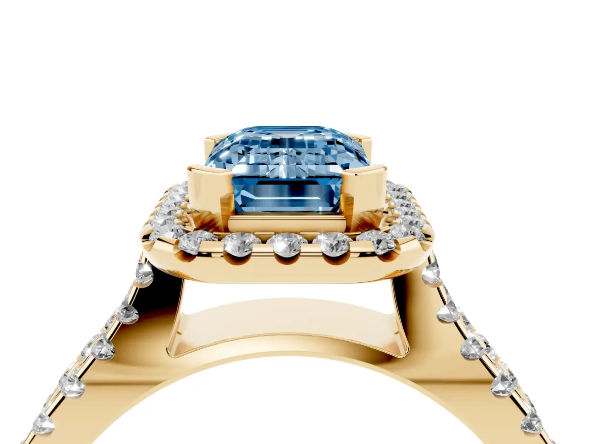 Fancy Blue Emerald Cut Diamond Halo Ring with Split Shank Pavé Band and Prong Setting Yellow gold