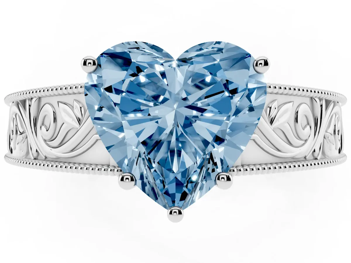 Fancy Blue Heart Cut Diamond Solitaire Ring with Engraved Band and Four-Prong Setting Silver
