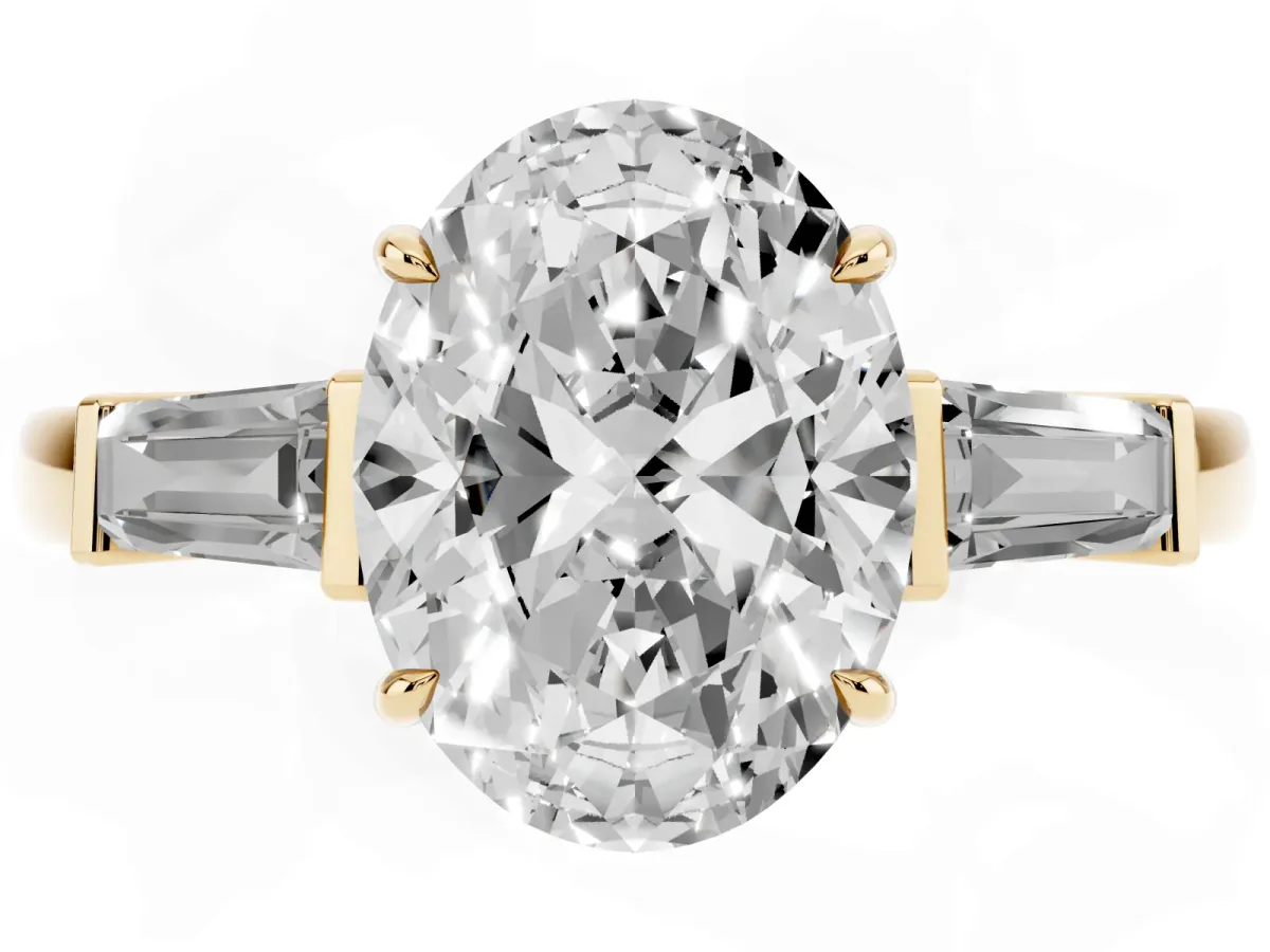 Oval Cut Diamond Three-Stone Ring with Tapered Baguette Side Stones and Prong Setting Yellow gold