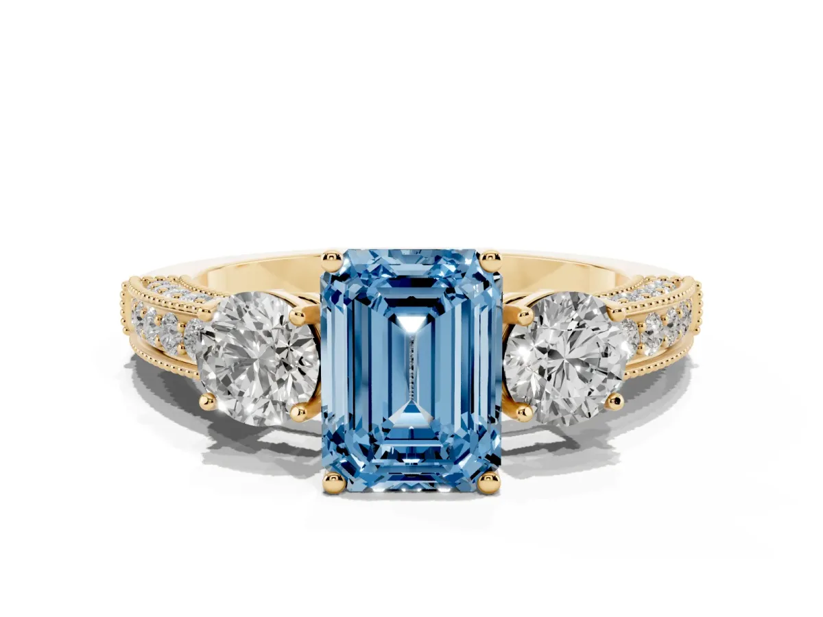 Fancy Blue Emerald Cut Three-Stone Diamond Ring with Pavé Band and Four-Prong Setting Yellow gold