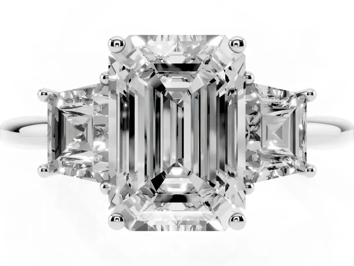 Emerald Cut Diamond Three-Stone Ring with Trapezoid Side Stones and Prong Setting Silver