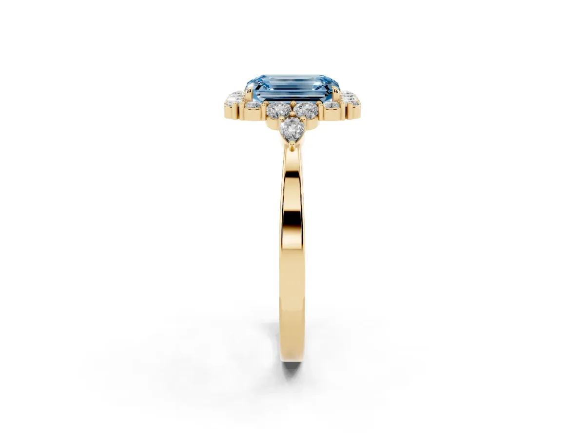 Fancy Blue Emerald Cut Diamond Halo Ring with Pear Side Stones and Prong Setting Yellow gold
