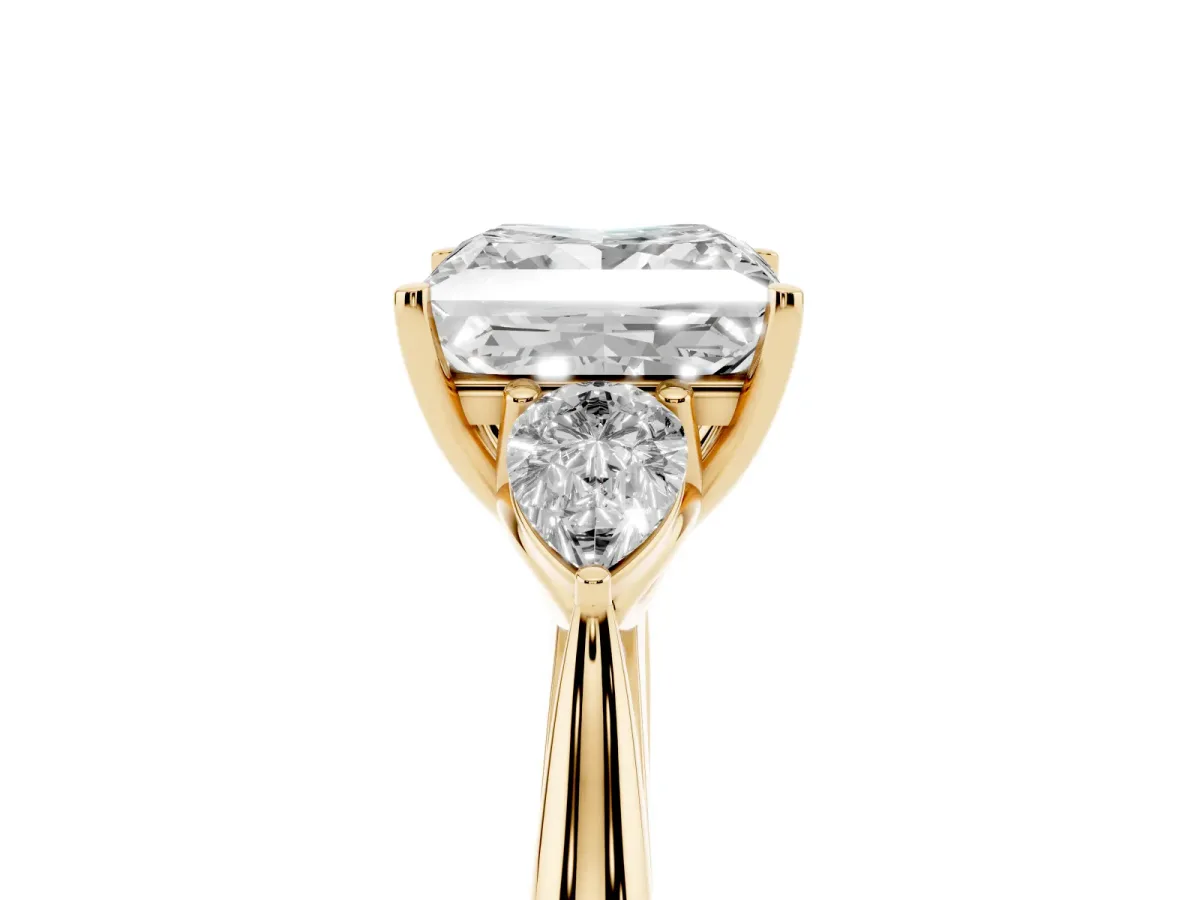 Three-Stone Princess Cut Diamond Ring with Pear Side Stones in Four-Prong Setting Yellow gold