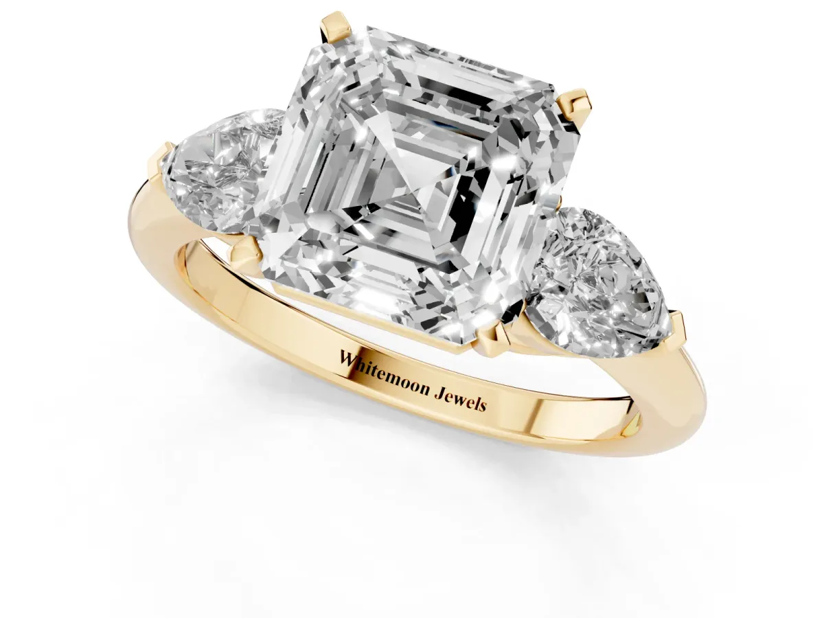 Three-Stone Asscher Cut Diamond Ring with Pear Side Stones and Four-Prong Setting Yellow gold