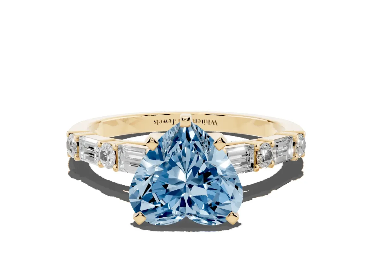 Fancy Blue Heart Cut Diamond Solitaire with Side Baguettes and Channel Set Band Yellow gold