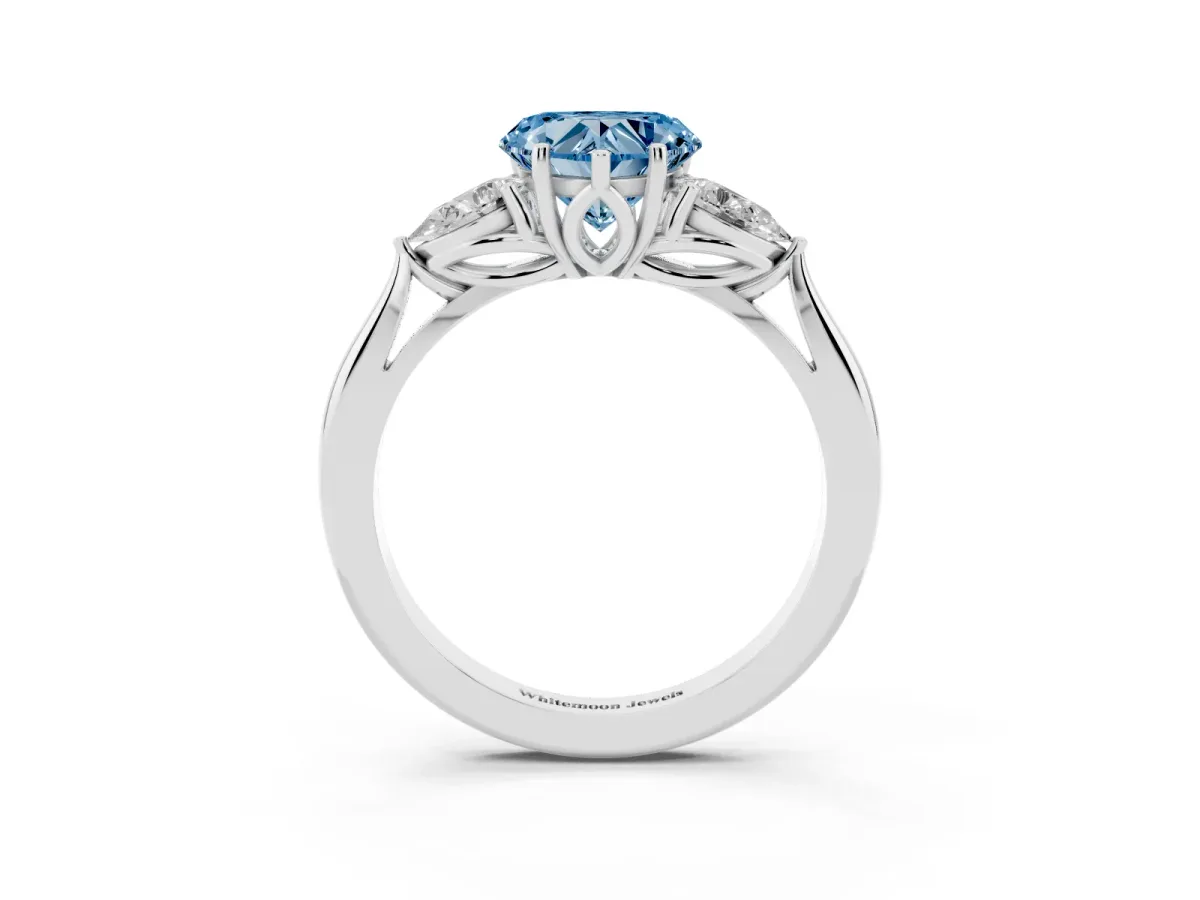 Fancy Blue Three-Stone Heart Cut Brilliant Diamond Solitaire Ring with Tapered Band and Four-Prong Setting White gold