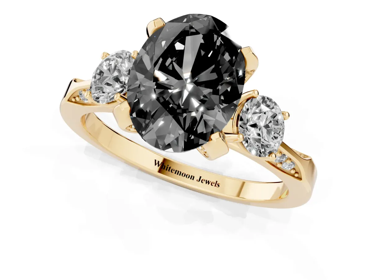 Fancy Black Oval Cut Brilliant Three-Stone Diamond Ring with Pavé Band and Four-Prong Setting Yellow gold