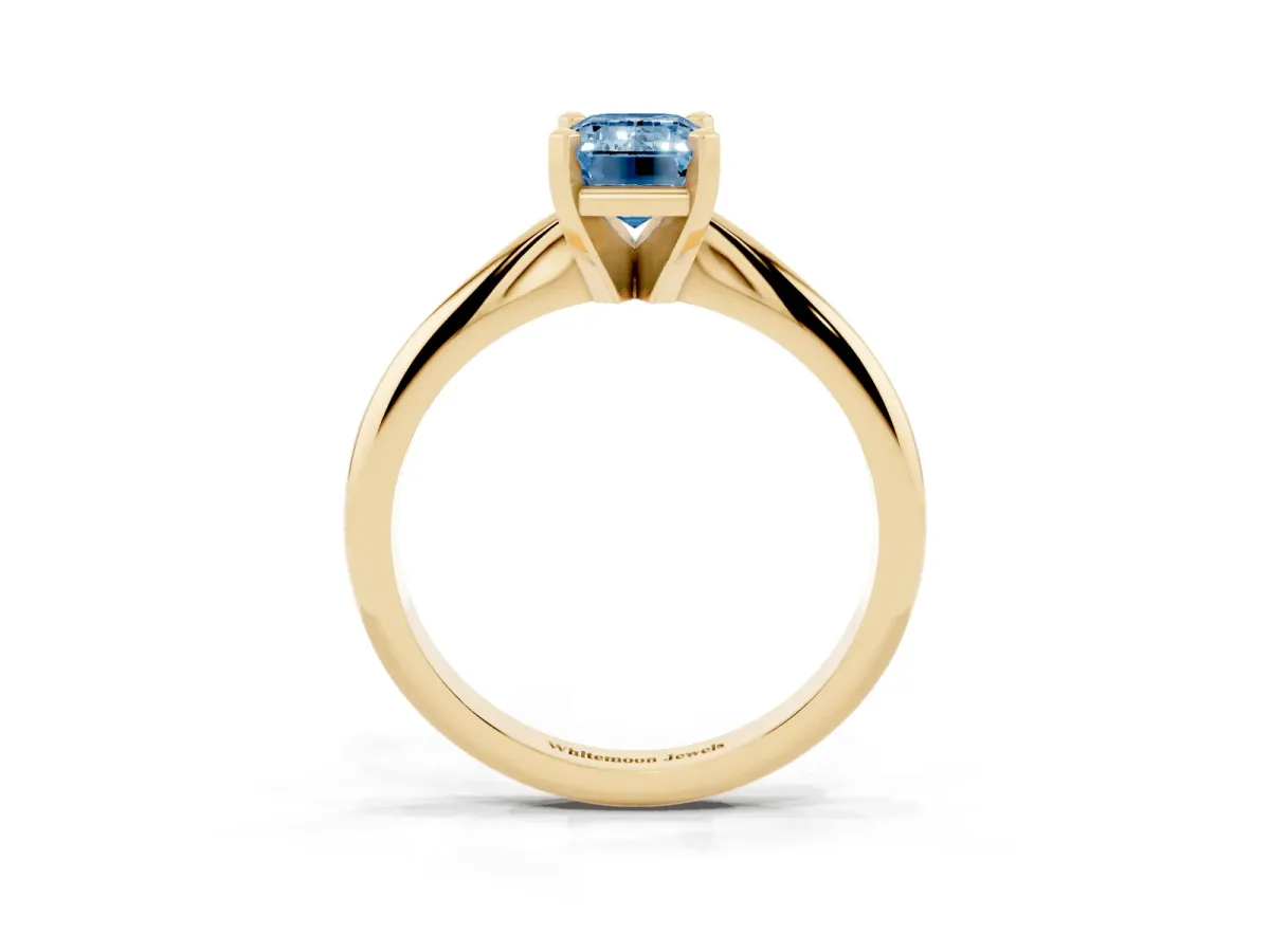 Fancy Blue Emerald Cut Cut Solitaire Ring with Four-Prong Setting on a Classic Band Yellow gold