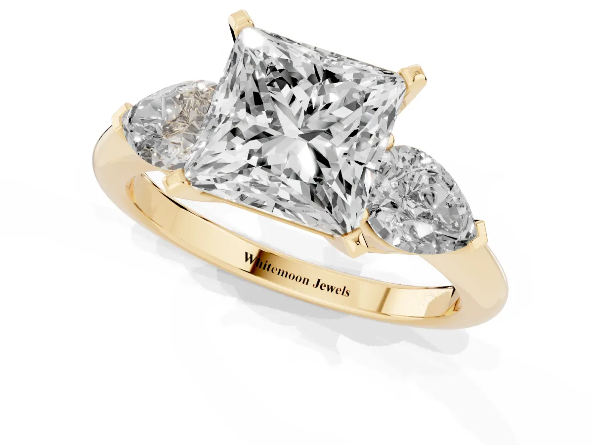 Three-Stone Princess Cut Diamond Ring with Pear Side Stones and Four-Prong Setting Yellow gold