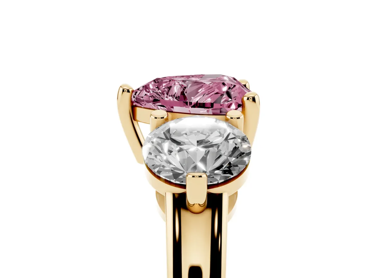 Fancy Pink Three-Stone Heart Cut Brilliant Cut Solitaire Ring with Prong Setting on a Classic Band Yellow gold