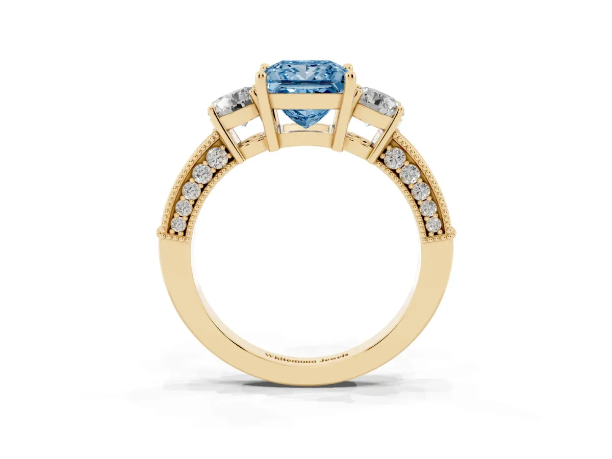 Fancy Blue Princess Cut Three-Stone Diamond Ring with Pavé Band and Four-Prong Setting Yellow gold