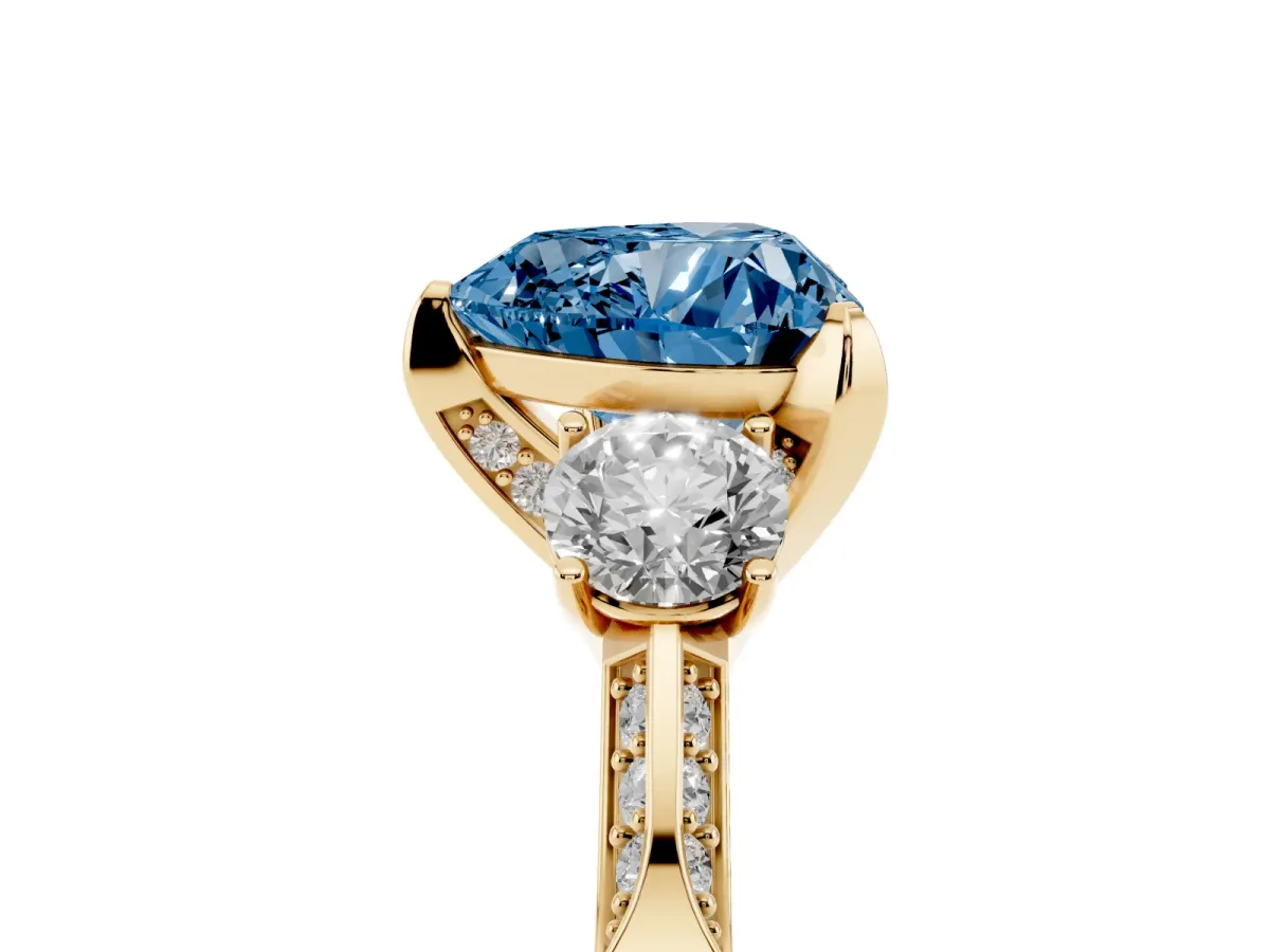 Fancy Blue Heart Cut Brilliant Three-Stone Diamond Ring with Pavé Band and Four-Prong Setting Yellow gold
