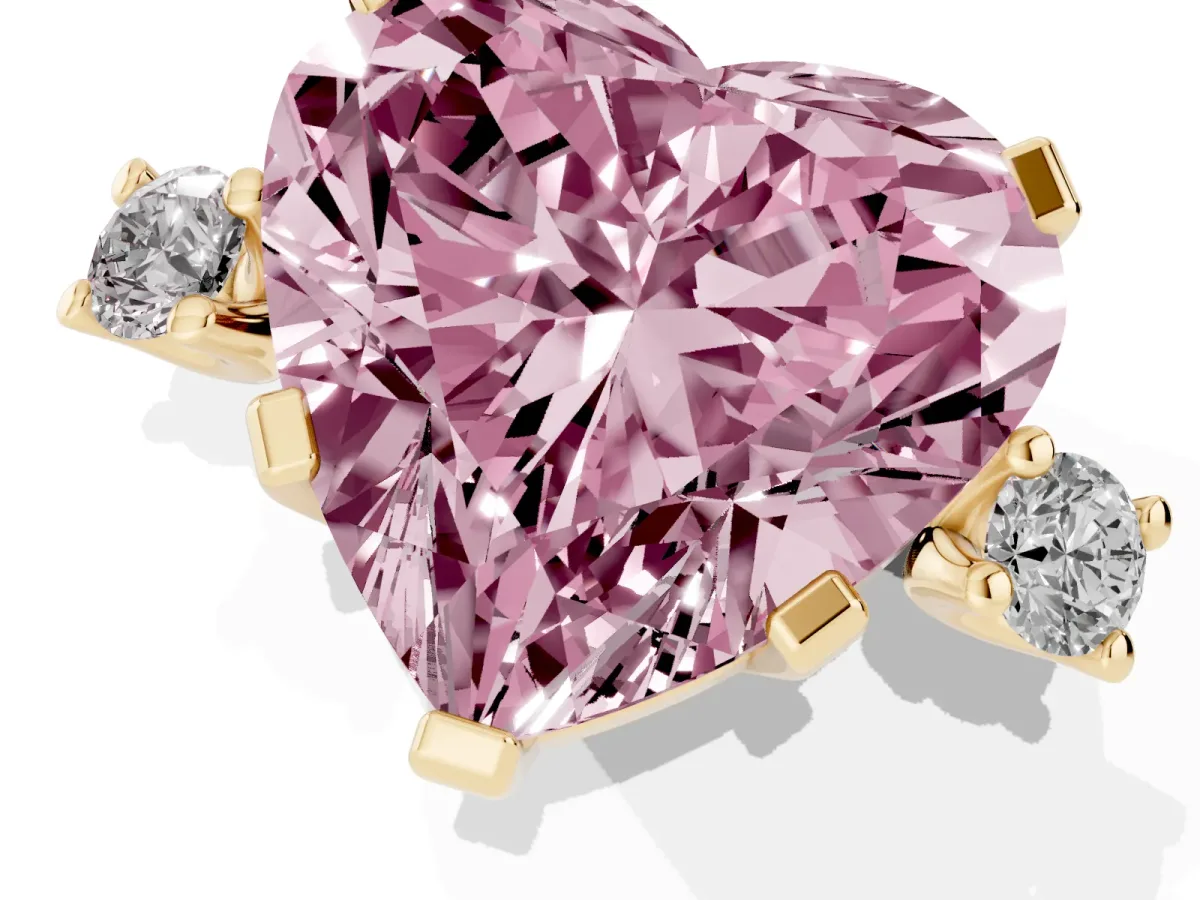 Fancy Pink Heart Cut Cut Three-Stone Solitaire Ring with Round Accent Diamonds and Four-Prong Setting Yellow gold