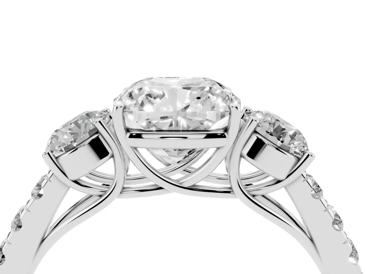 Cushion Cut Cut Diamond Three-Stone Ring with Round Side Stones and Pavé Band Platinum