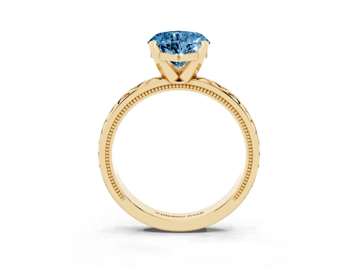 Fancy Blue Heart Cut Solitaire Diamond Ring with Milgrain and Black Enamel X Pattern Band Yellow gold