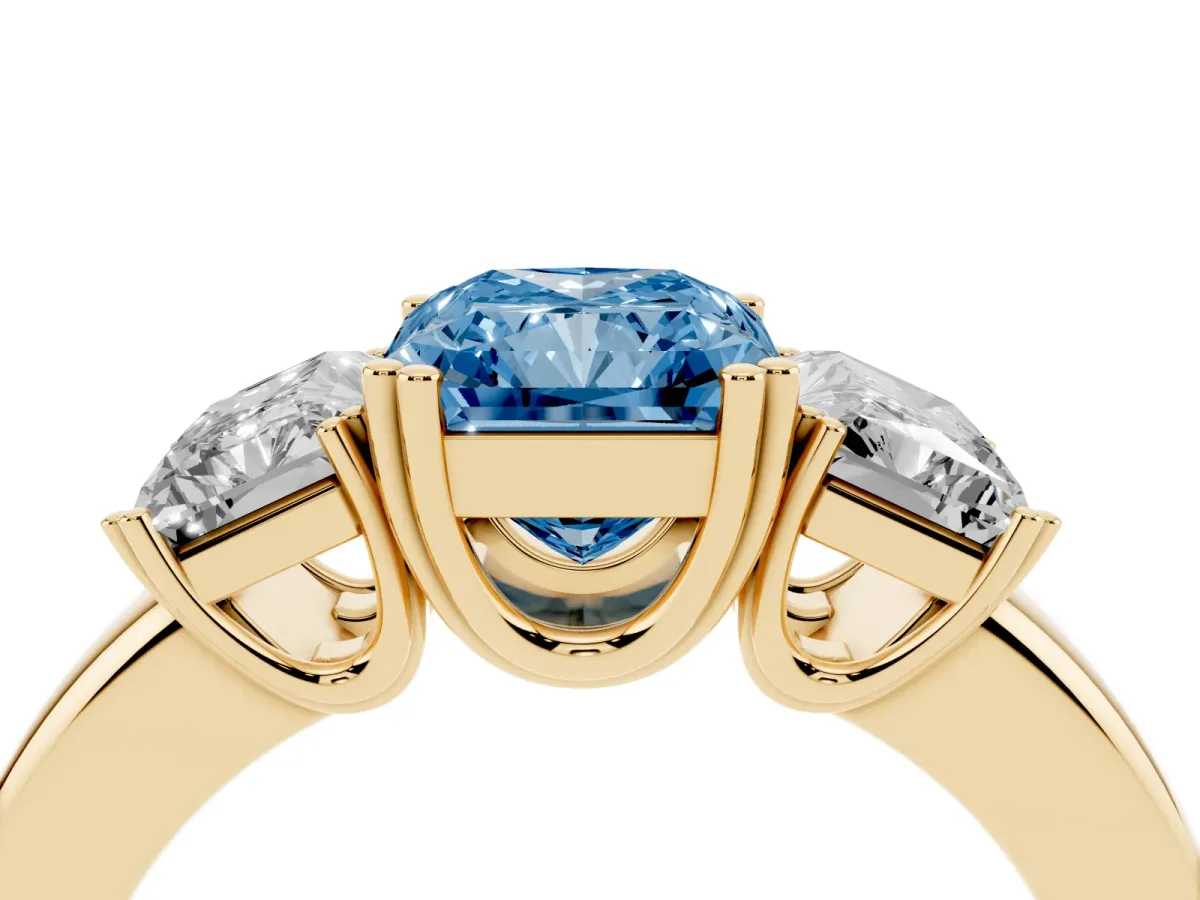 Fancy Blue Three-Stone Radiant Cut Cut Diamond Ring with Channel Set Band and Four-Prong Setting Yellow gold
