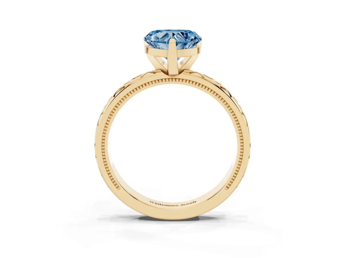Fancy Blue Heart Cut Solitaire Engagement Ring with Scrollwork Band and Four-Prong Setting Yellow gold