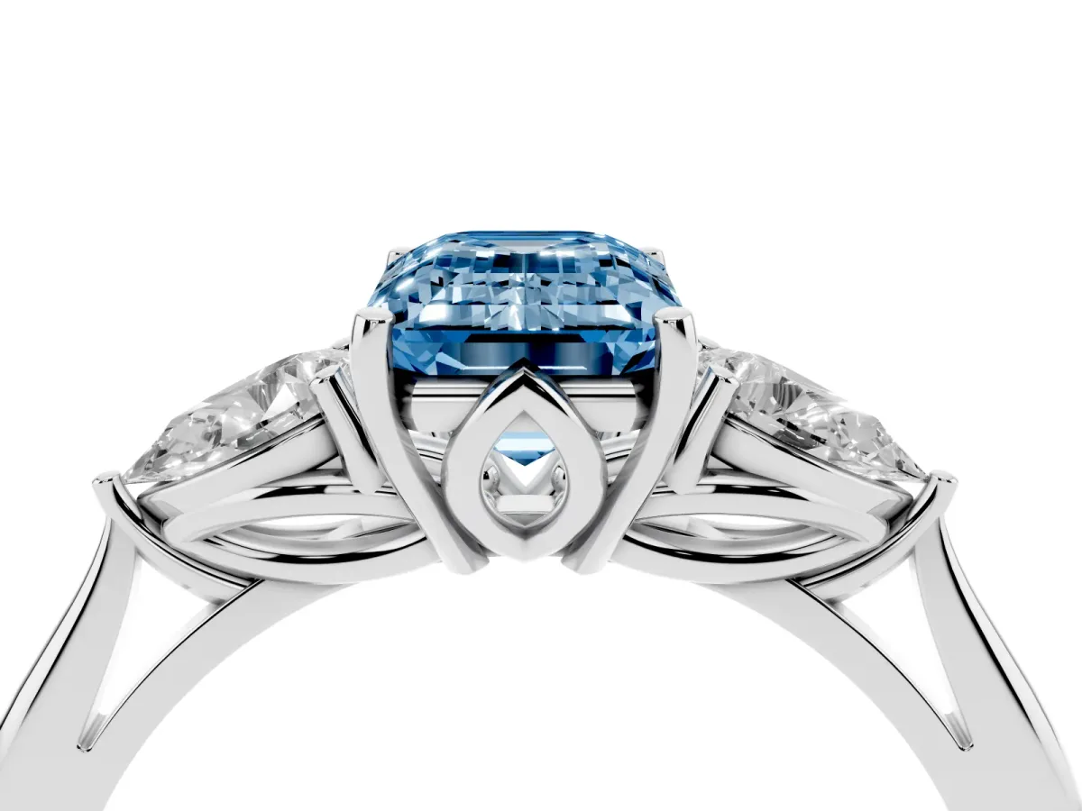 Fancy Blue Three-Stone Emerald Cut Diamond Ring with Pear Side Stones in Four-Prong Setting Silver