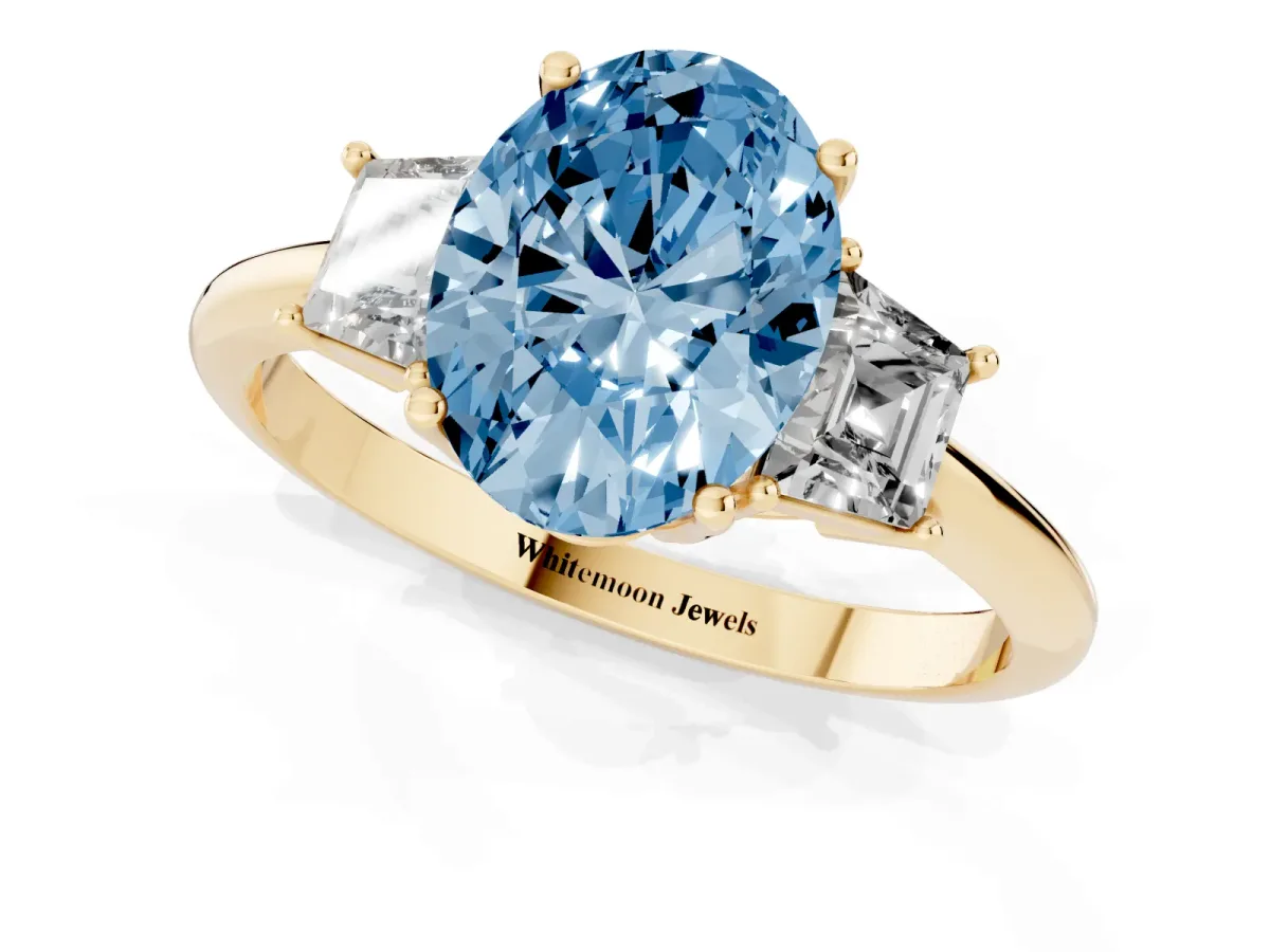 Fancy Blue Oval Cut Diamond Three-Stone Ring with Trapezoid Side Stones and Prong Setting Yellow gold
