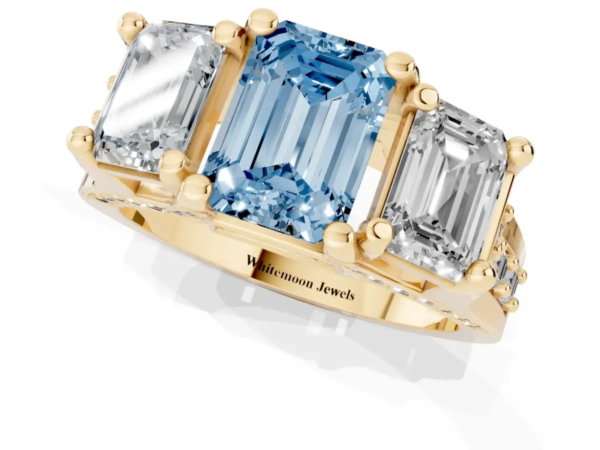 Fancy Blue Emerald Cut Diamond Three-Stone Ring with Channel Set Band and Four-Prong Setting Yellow gold