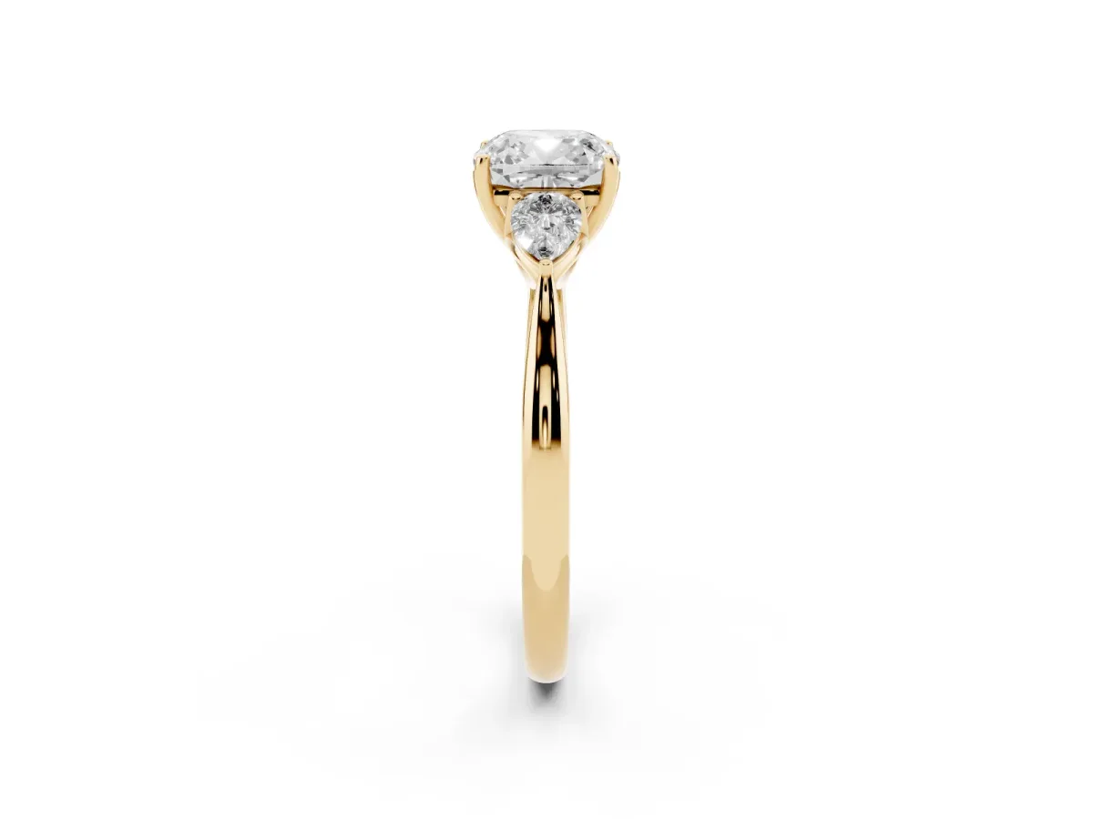 Cushion Cut Diamond Three-Stone Ring with Pear Side Stones and Prong Setting Yellow gold