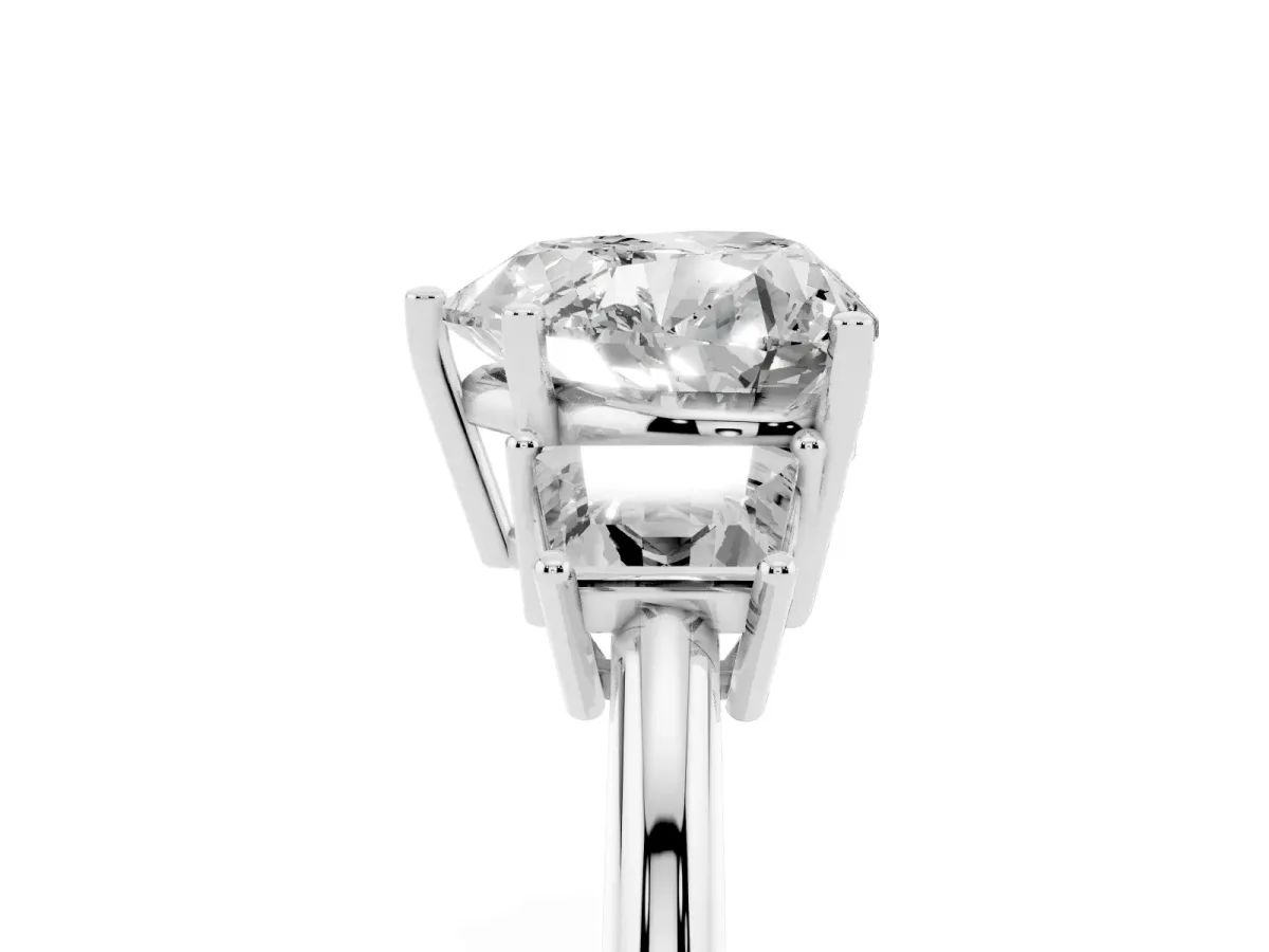 Heart Cut Diamond Three-Stone Ring with Trapezoid Side Stones and Prong Setting Platinum