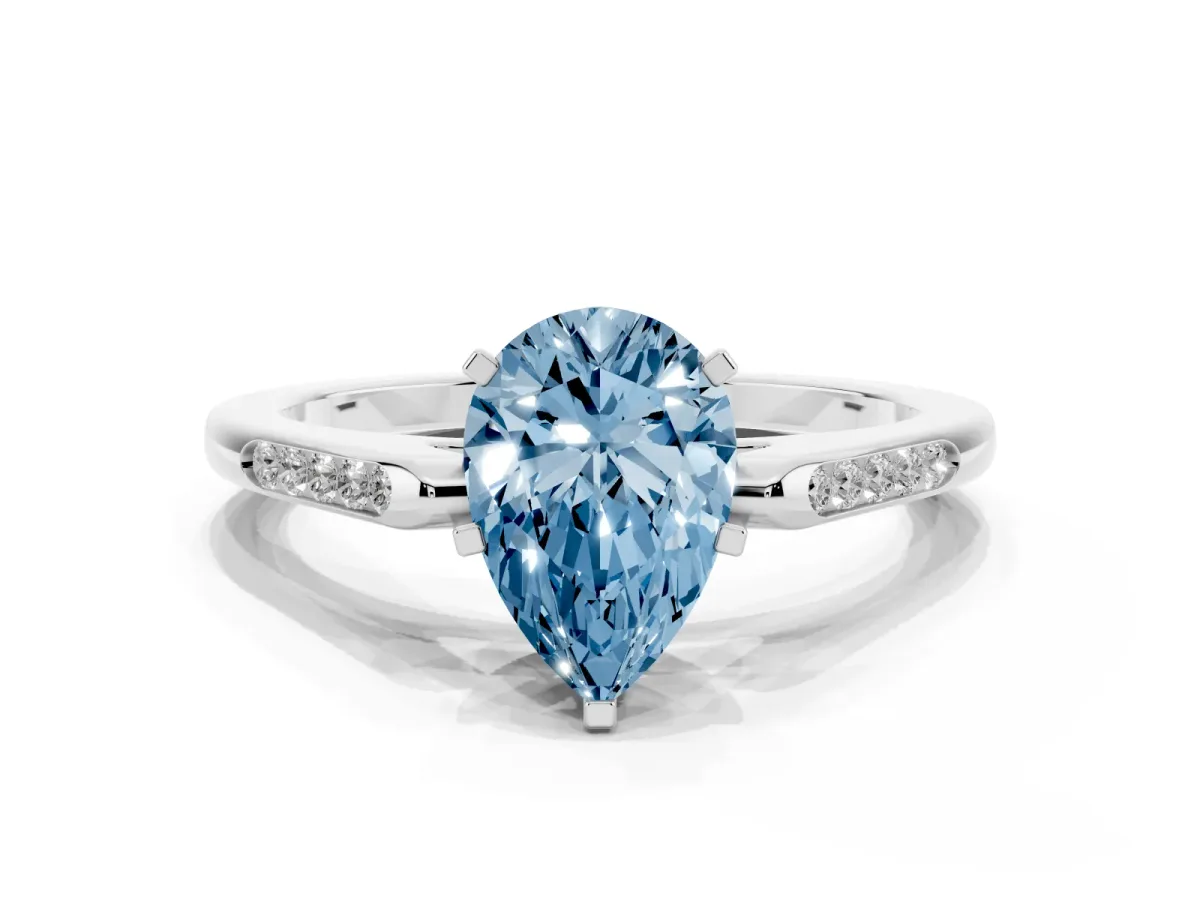 Fancy Blue Pear Cut Diamond Solitaire Ring with Channel Set Round Band and Prong Setting Silver