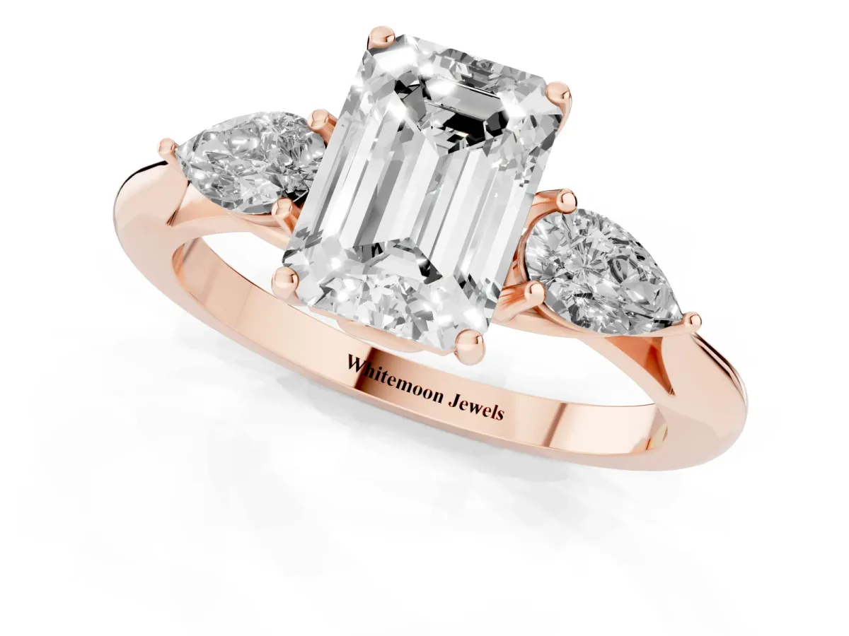 Three-Stone Emerald Cut Diamond Ring with Pear Side Stones in Four-Prong Setting Rose gold