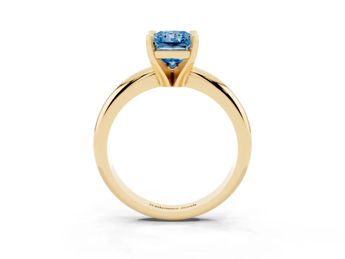 Fancy Blue Radiant Cut Diamond Solitaire Engagement Ring with Round Band and Four-Prong Setting Yellow gold