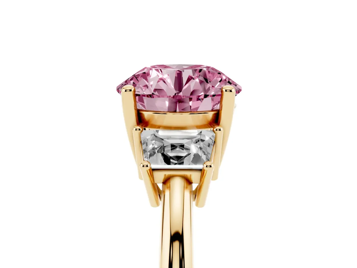 Fancy Pink Round Cut Diamond Three-Stone Ring with Trapezoid Side Stones and Prong Setting Yellow gold