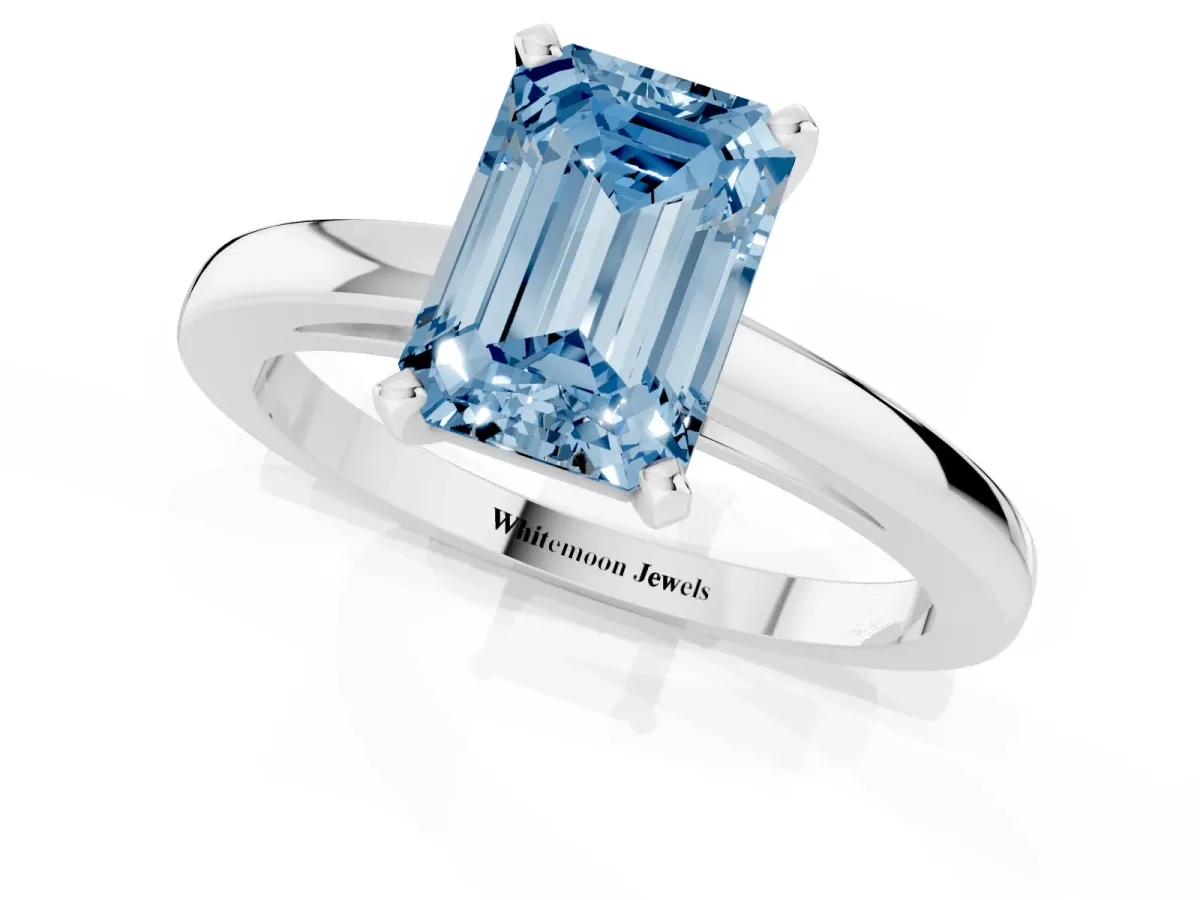Fancy Blue Emerald Cut Solitaire Diamond Engagement Ring with Four-Prong Setting on a Classic Band Silver